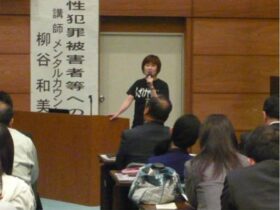 講演会で自身の過去を語る柳谷さん